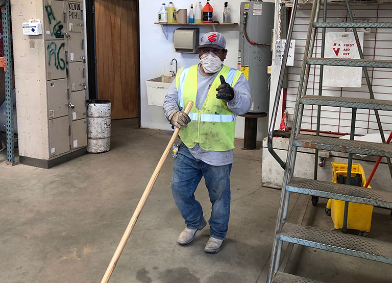 Geomy Pohl employee sweeping up